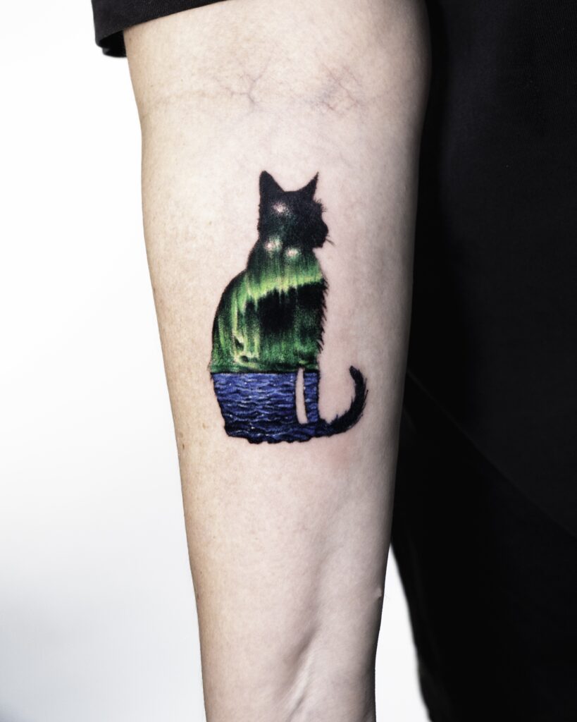 Cat silhouette tattoo with northern lights design