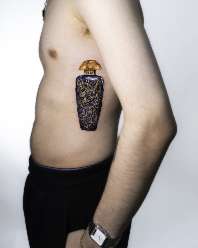 Tattoo of a perfume bottle design.