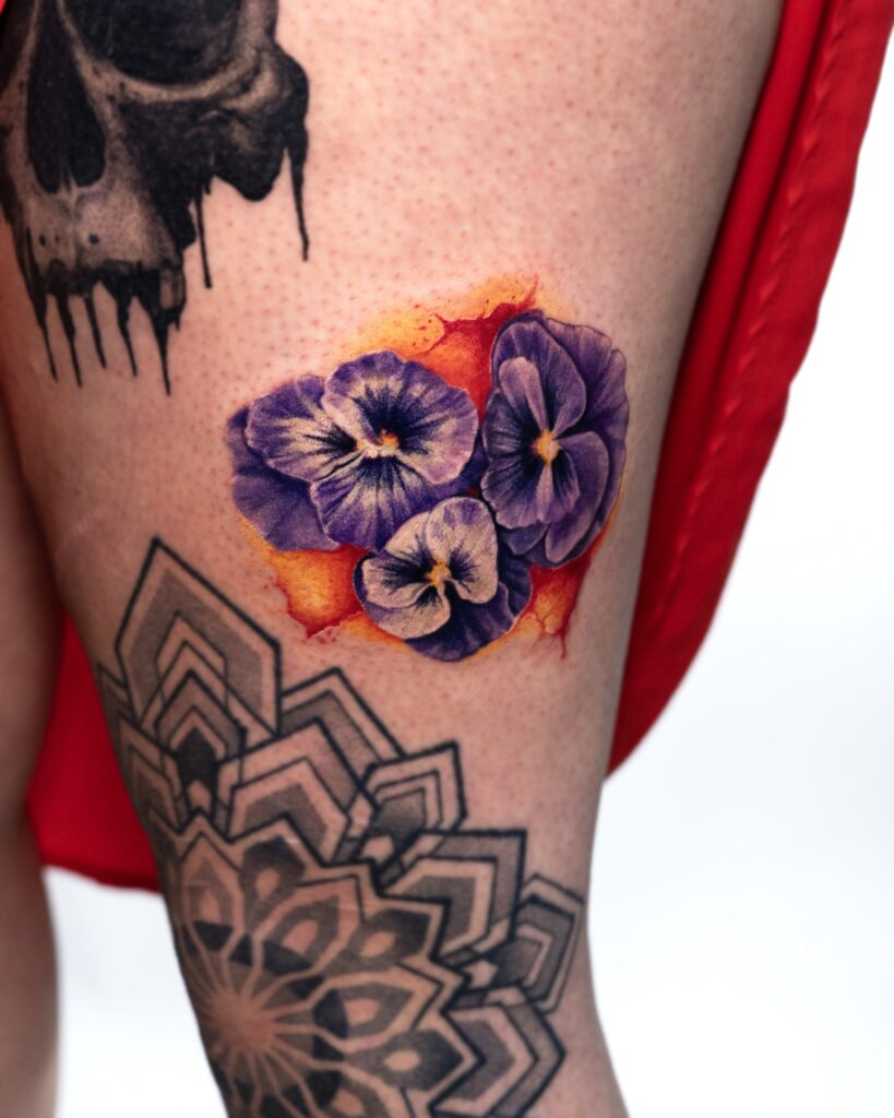 Purple violet bouquet tattoo on leg.