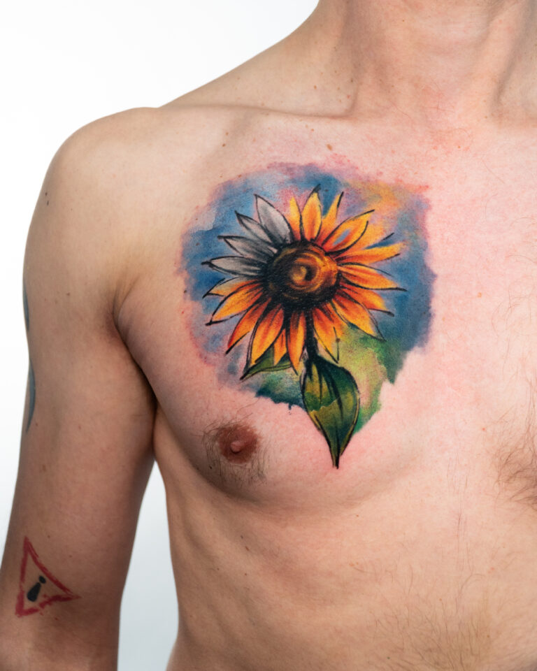 Vibrant sunflower tattoo on chest.